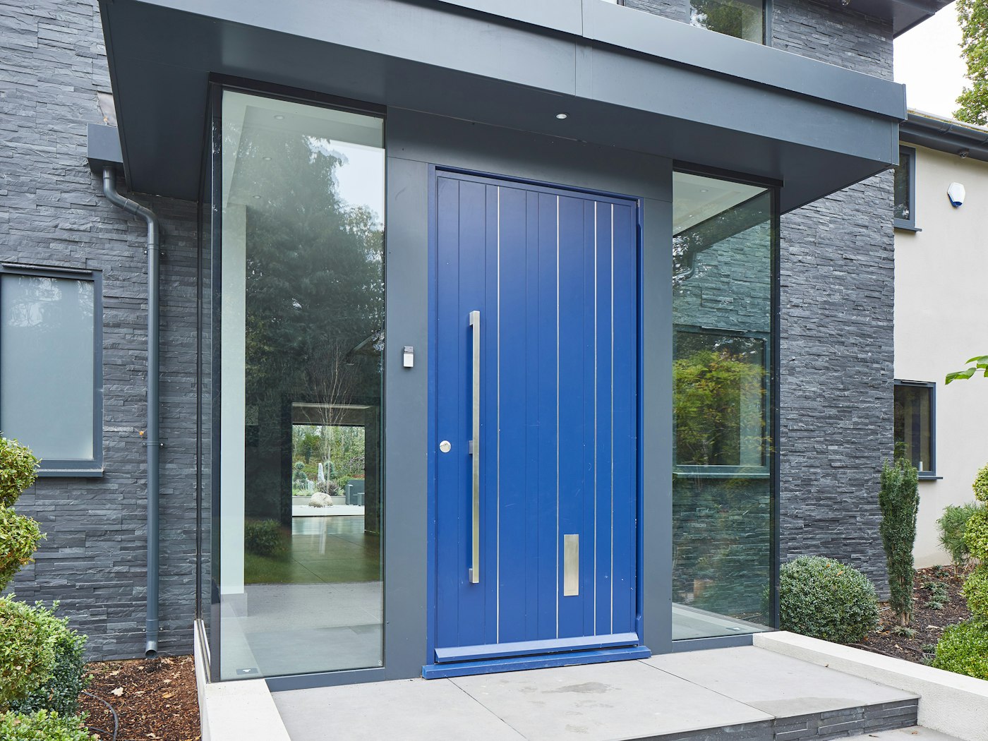 this glass box entrance certainly creates an attractive result