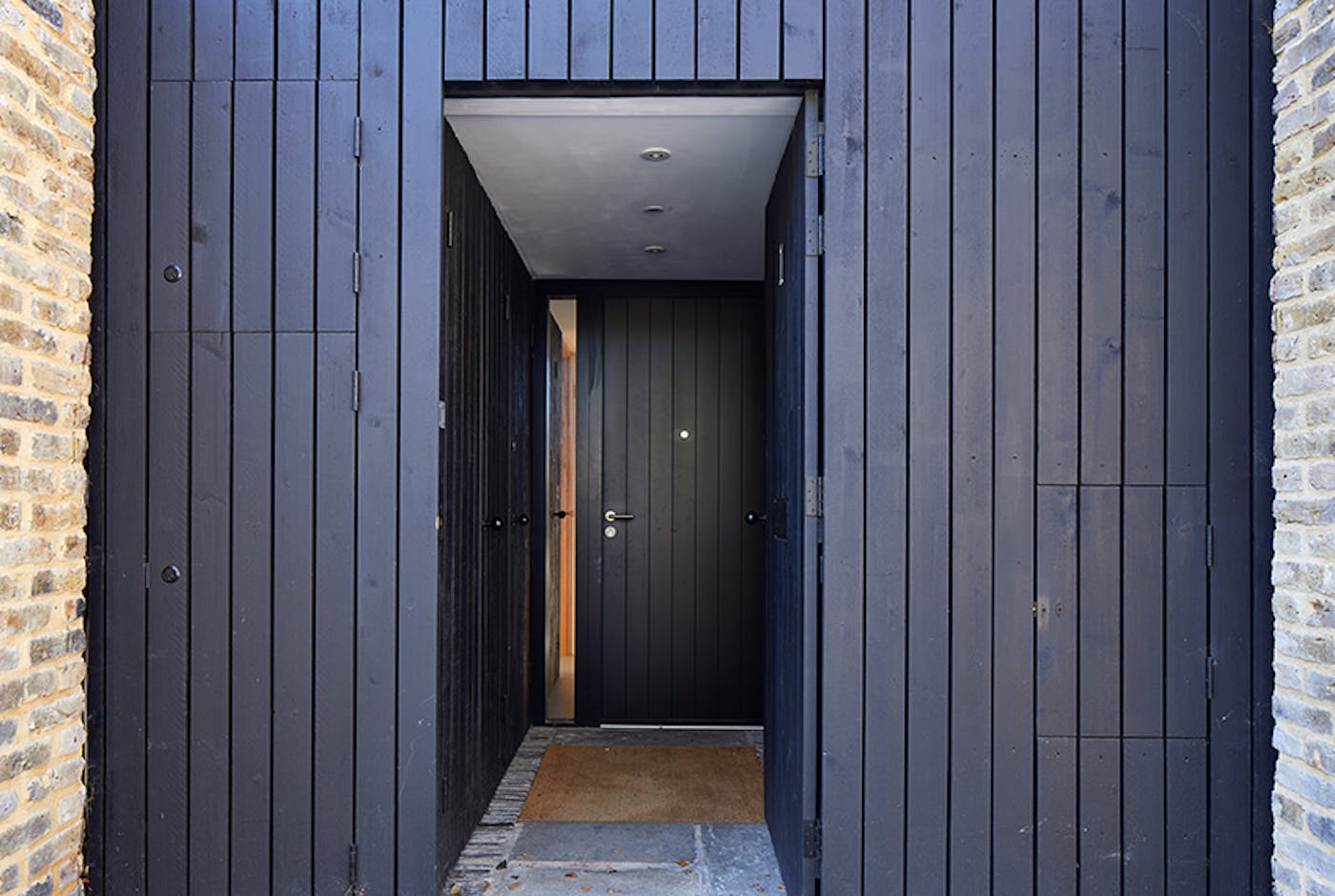 Black door with black cladding