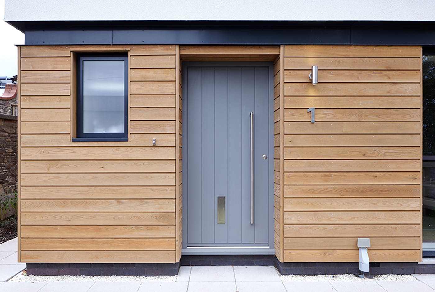 Steel beams, cladding and white render choosing a light grey is safe but also effective