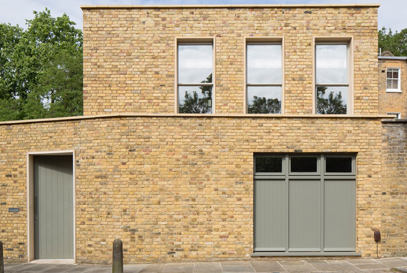 A sage green colour lifts the yellowish brick