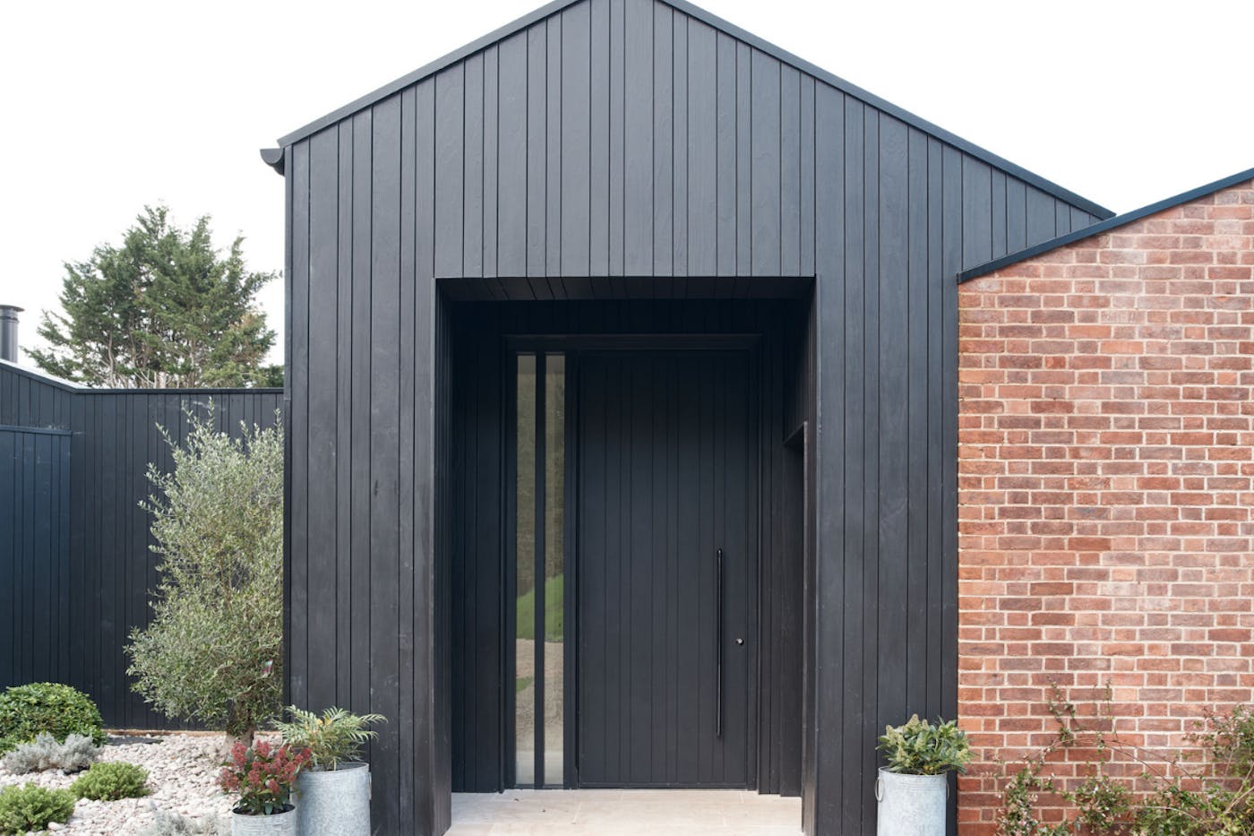 A great example of the impact you can create by matching door and cladding.