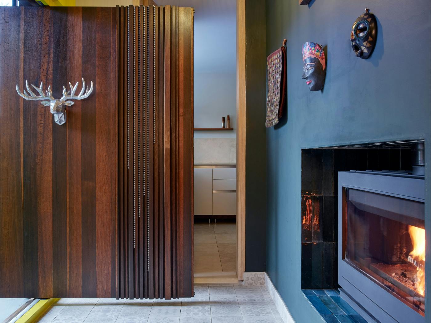 Sleek silver decorations enhanced by the addition of a roaring fire.