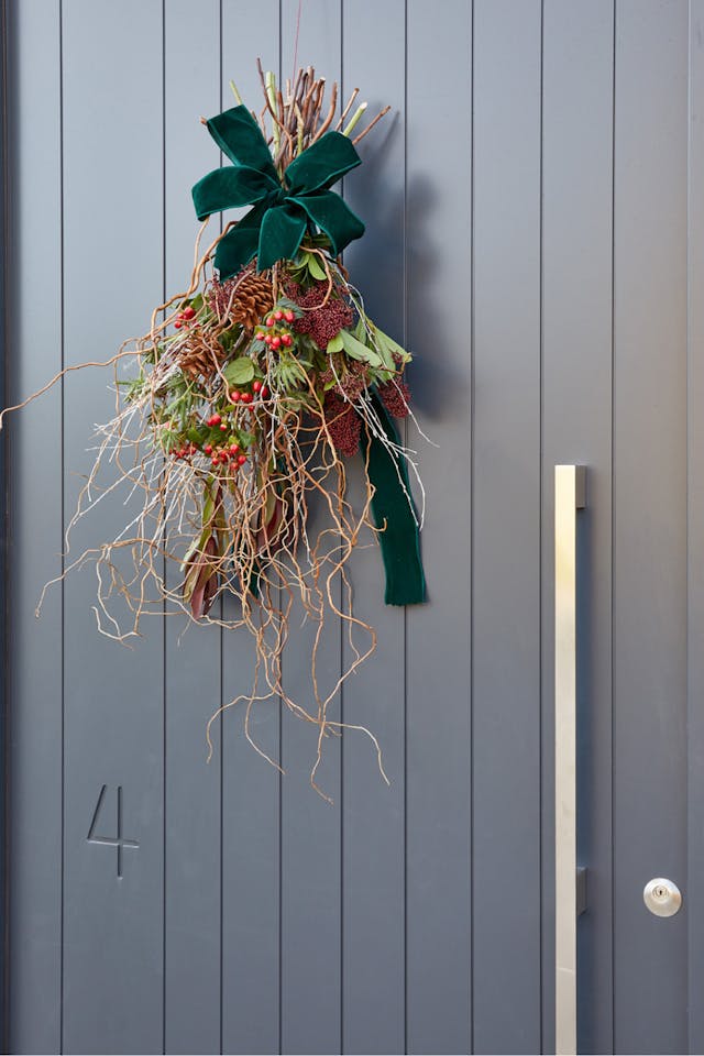Portrait dark grey door and wreath