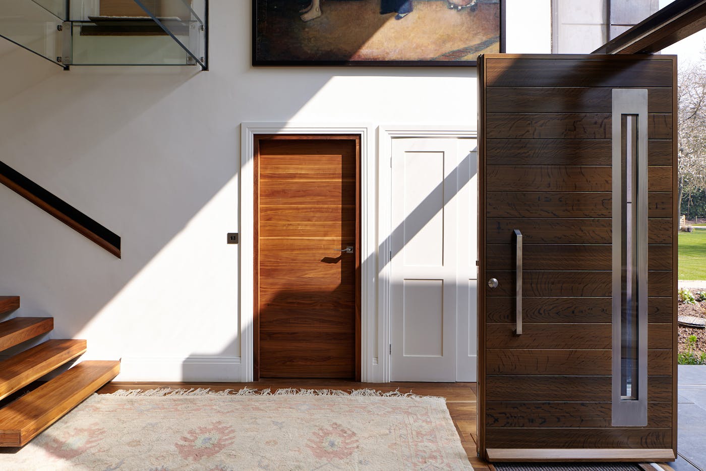 The addition of a patterned rug and striking art give a little traditional flair to the modern build and interiors