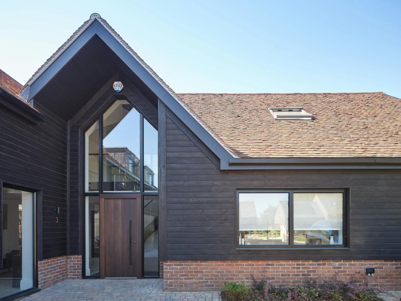 Fumed oak combined with black cladding and brick makes a style statement 
