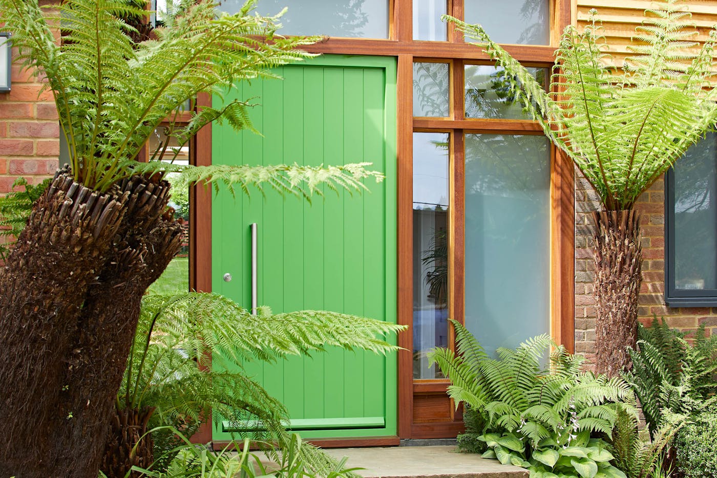 Bright green, warm wood and glass creates a gorgeous entrance