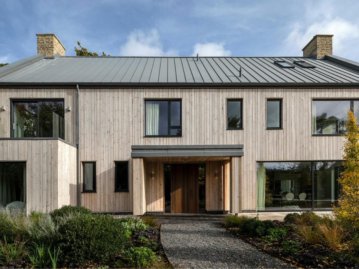 This fumed oak Milano V is set in two sidelights and within a generous porch