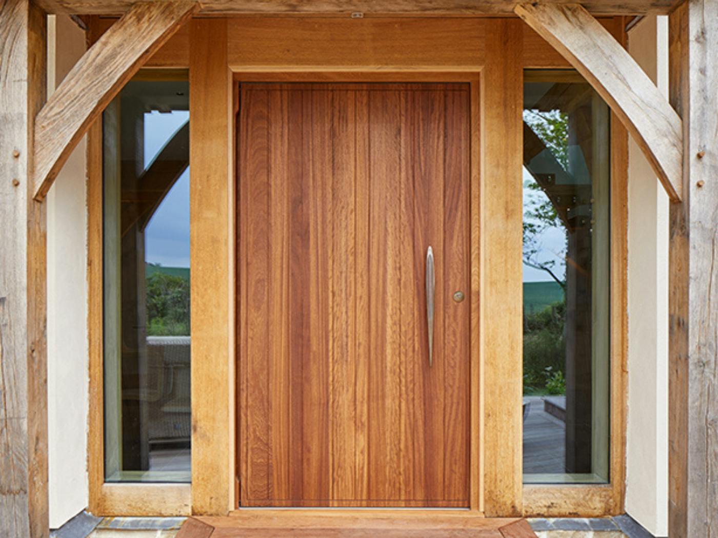 This traditional layout is the perfect frame for this beautiful front door with bronze handle