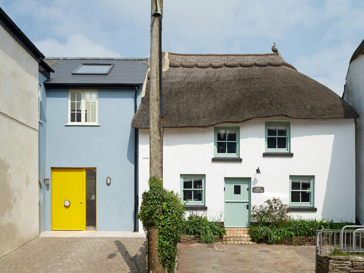 A yellow door with one sidelight creates the wow factor