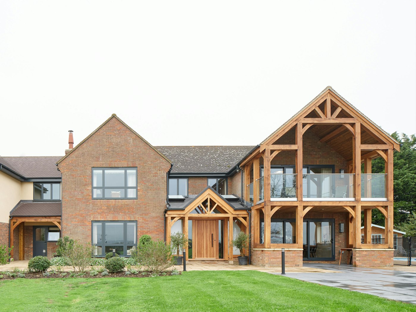 The house includes an impressive covered balcony with oak beams