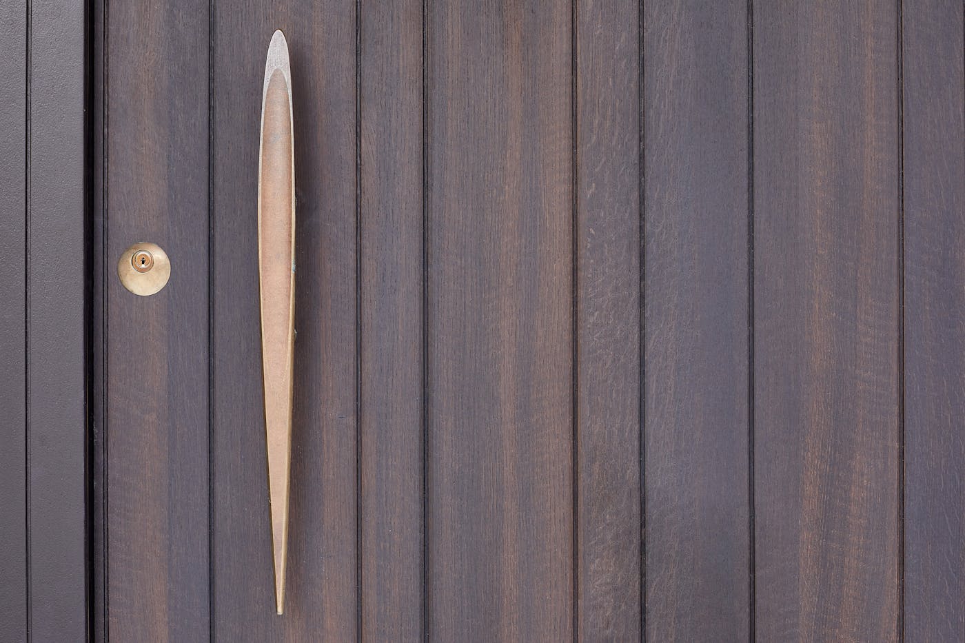 A designer solid cast bronze pull with a dip detail makes a real statement