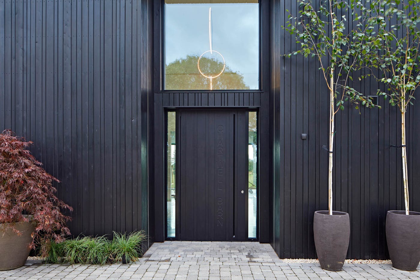 Matching an ebony-oiled wood front door to shou sugi ban cladding is increasingly popular