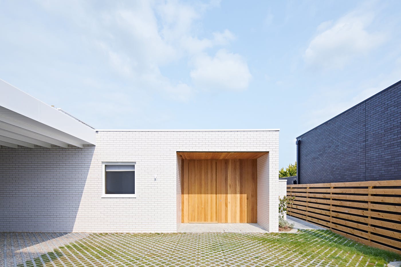 This flush, pivot door is set well back under a broad overhang with side walls for added protection 