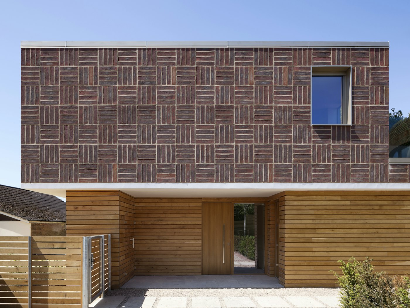 Far from boring, the careful design of this house uses red brick in a thoroughly modern way