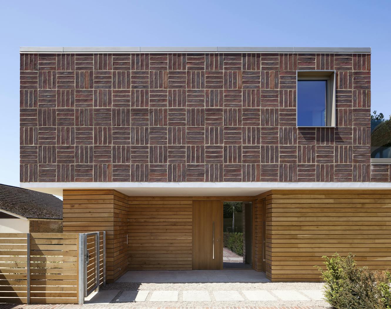 Far from boring, the careful design of this house uses red brick in a thoroughly modern way