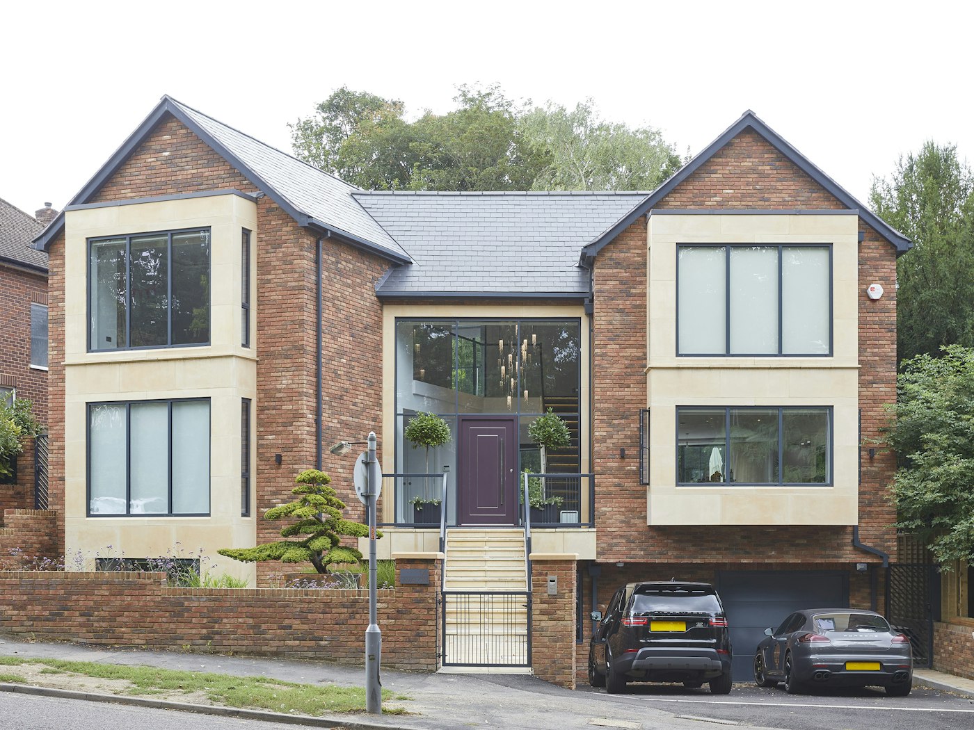 Keeping it simple - but unique - this mixed style modern house offsets the more traditional red brick with a wealth of glass and our Form door in purple for a contemporary upgrade