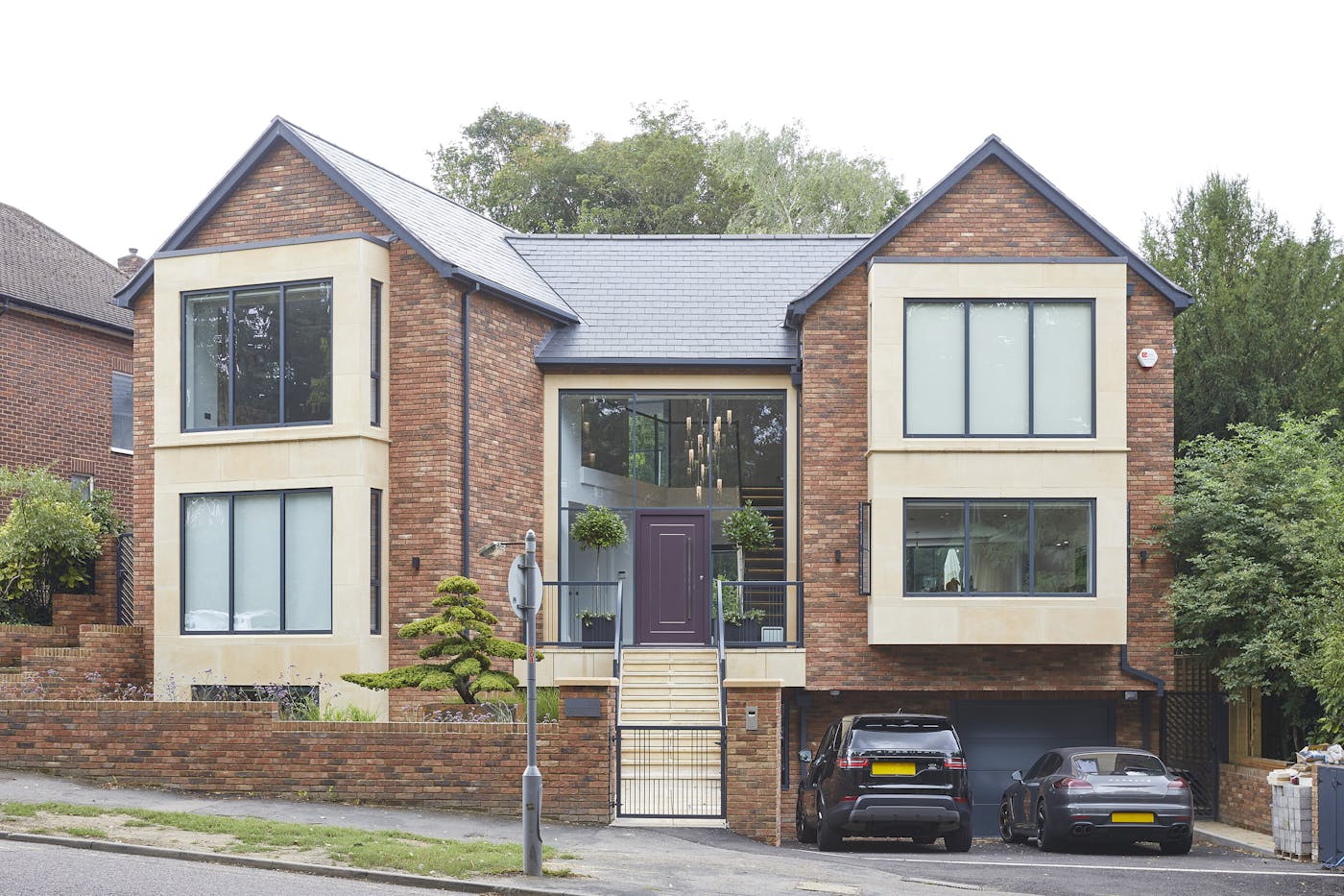Keeping it simple - but unique - this mixed style modern house offsets the more traditional red brick with a wealth of glass and our Form door in purple for a contemporary upgrade