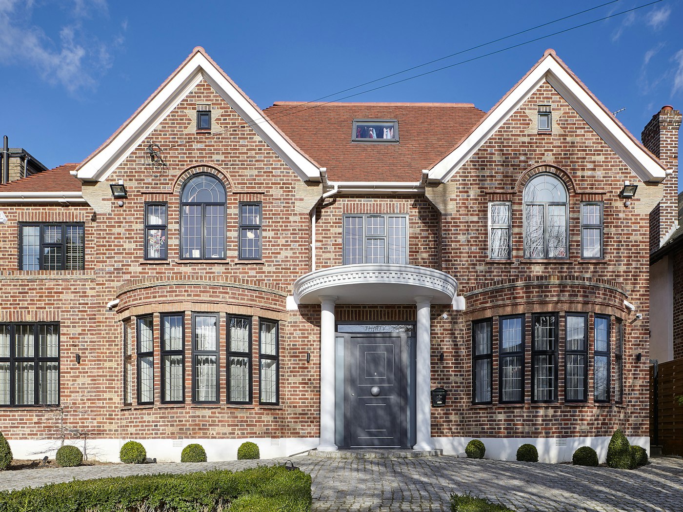 This traditionally styled house has had a thoroughly modern makeover with an Urban Front grey painted front door