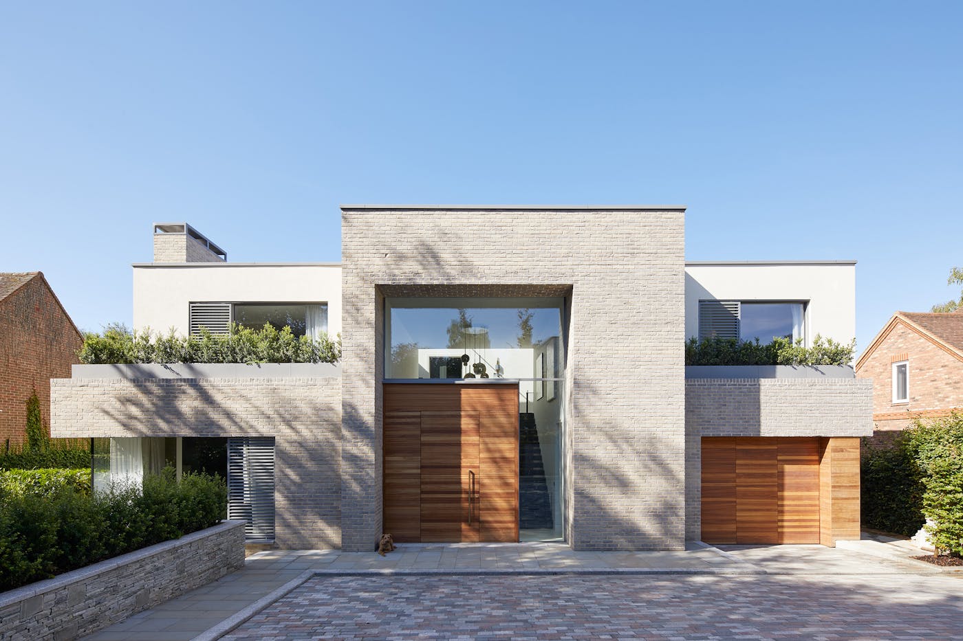 An all-rounder, iroko also works very well with the lighter beige/grey brick of this new build