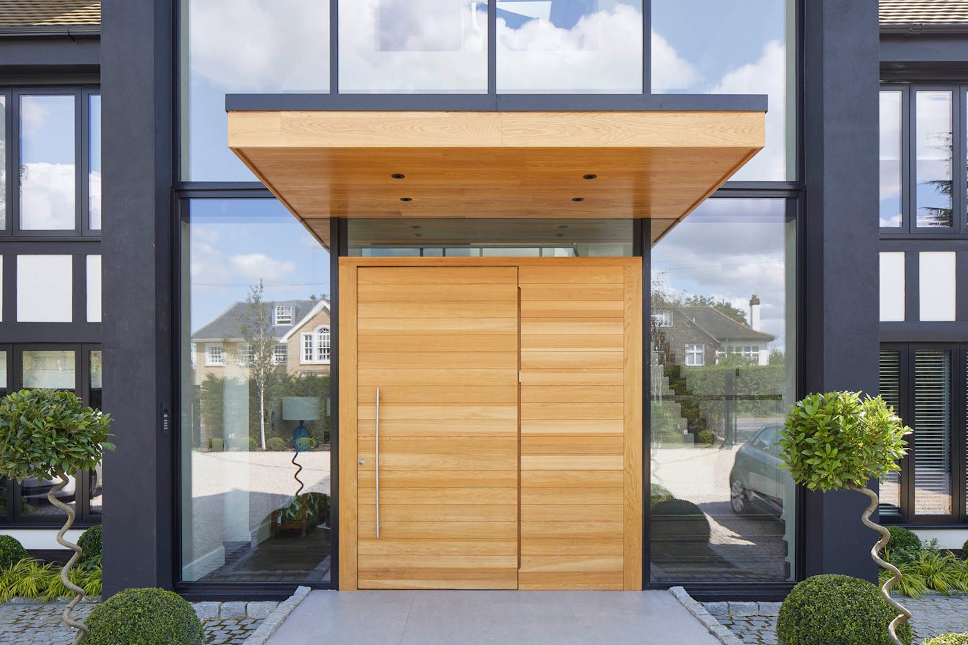 large overhangs will help protect a pivot door from exposure