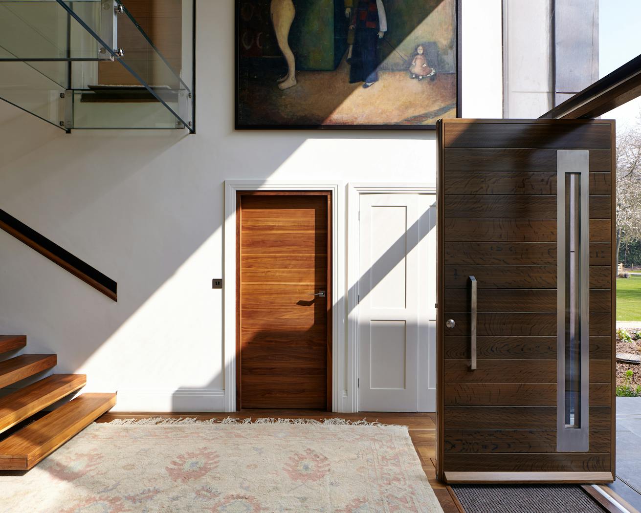 The hallway is an inviting space with white walls and warm woods