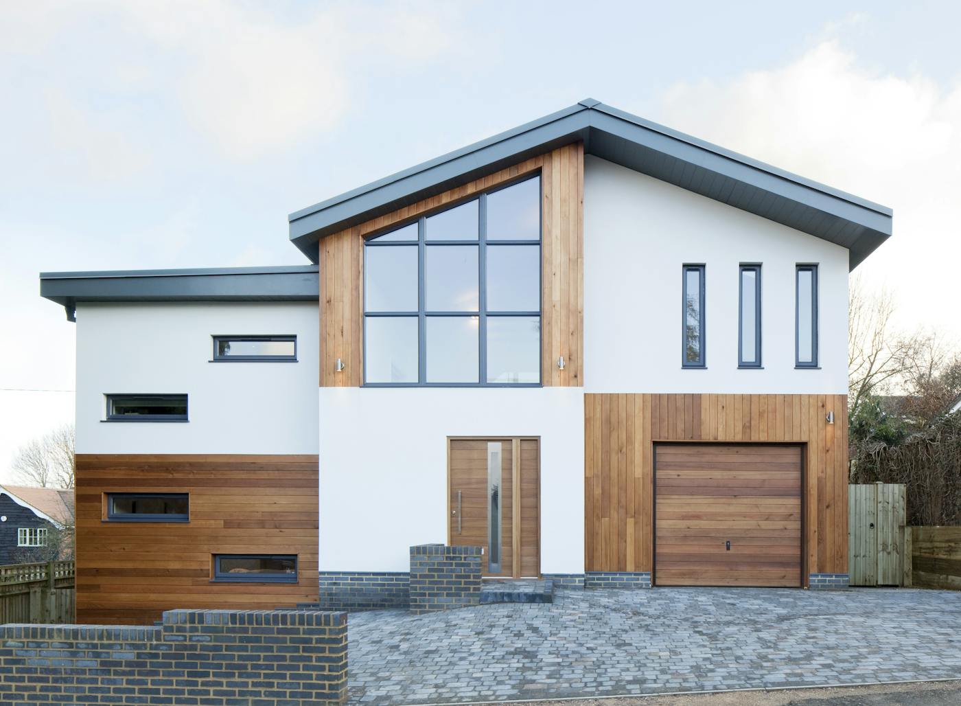 The Sorrento door by Urban Front works beautifully with the wood cladding and garage door