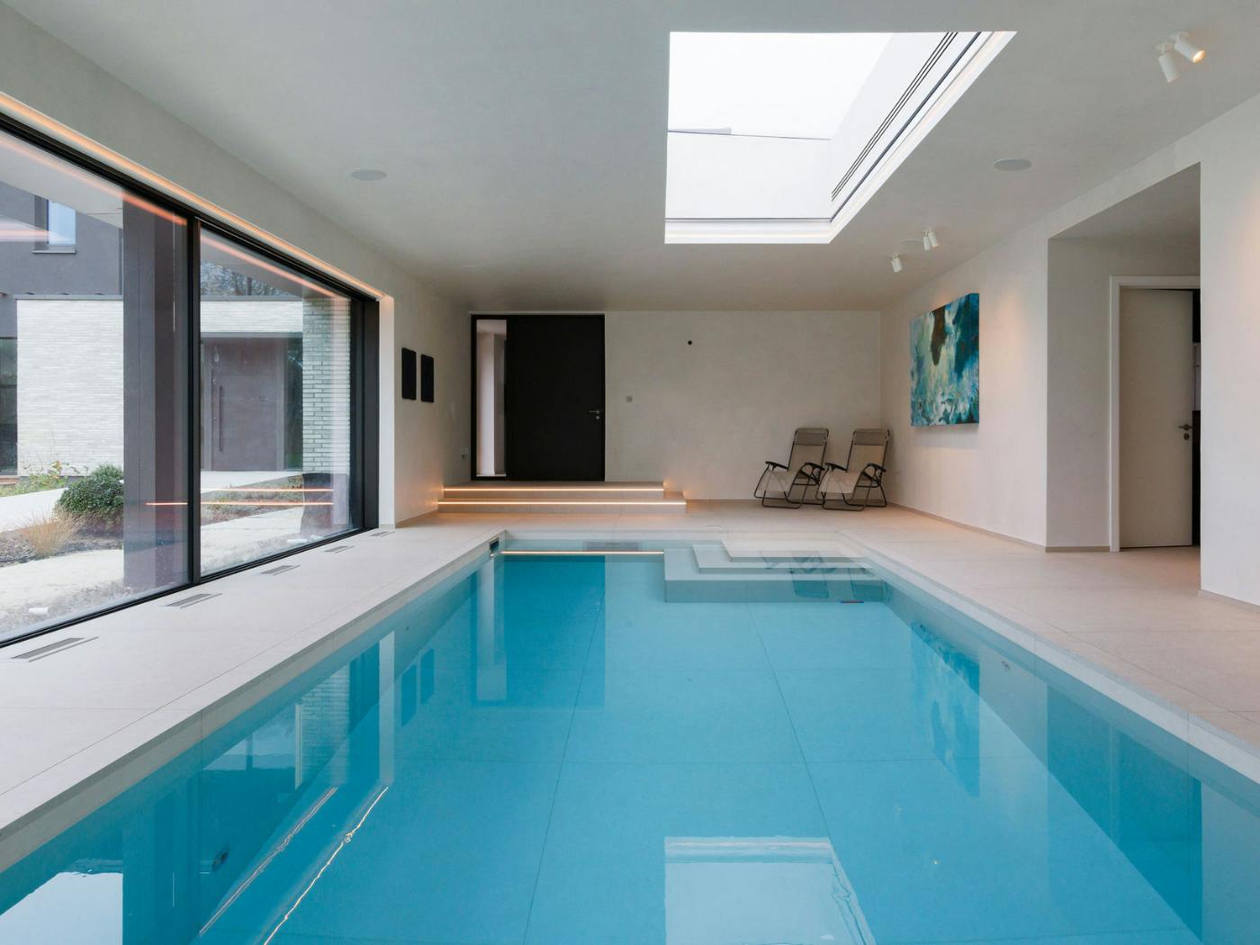 The dark grey internal door echoes the bronze of the external main door (visible through the window)