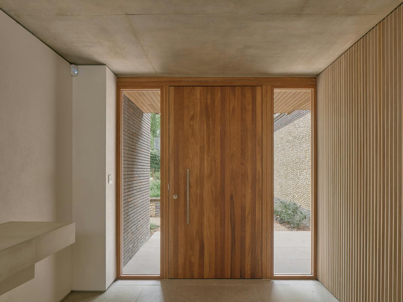 Simple, warm and textural with a focus on natural materials with the door taking centre stage.