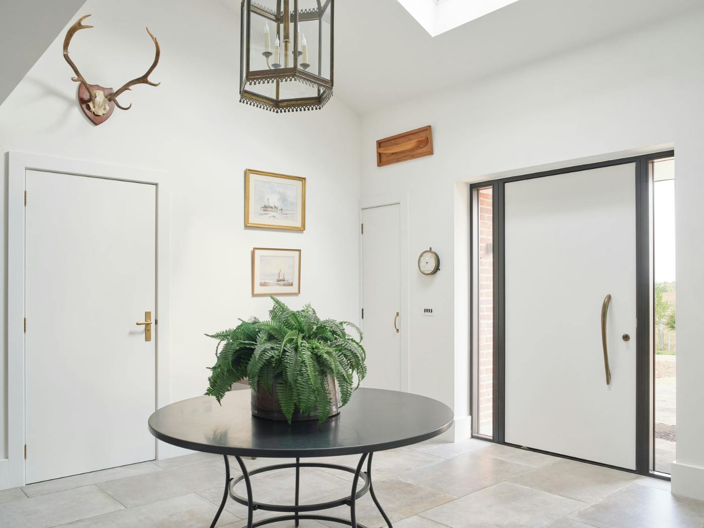 Monochrome hallway with the colour of the internal door matching the main door