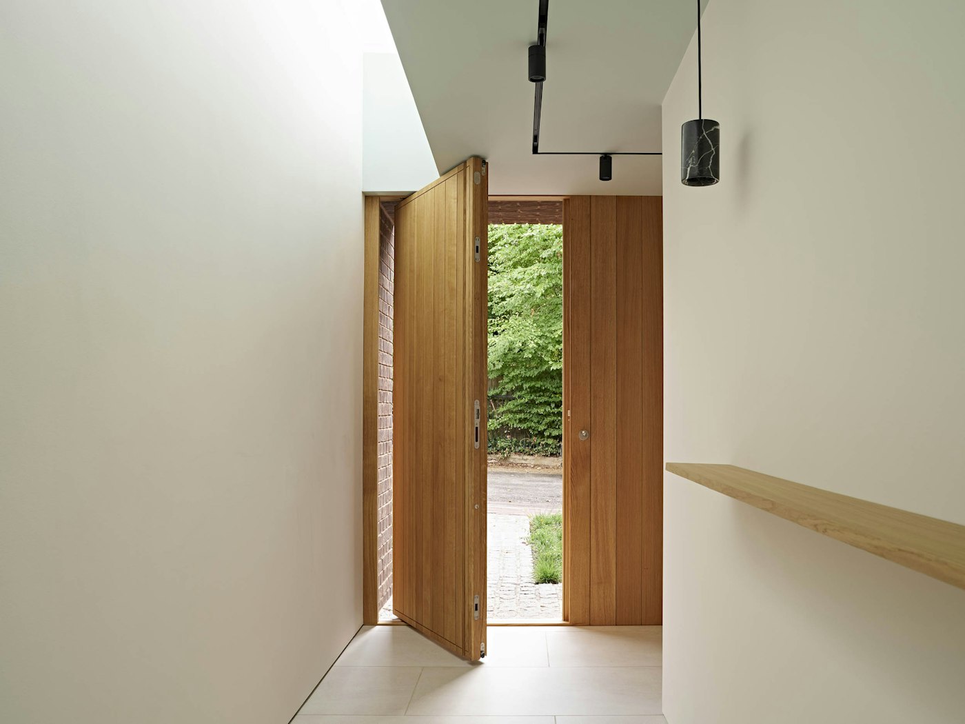 The Porto in oak was chosen with a pivot front door opening for a contemporary feel
