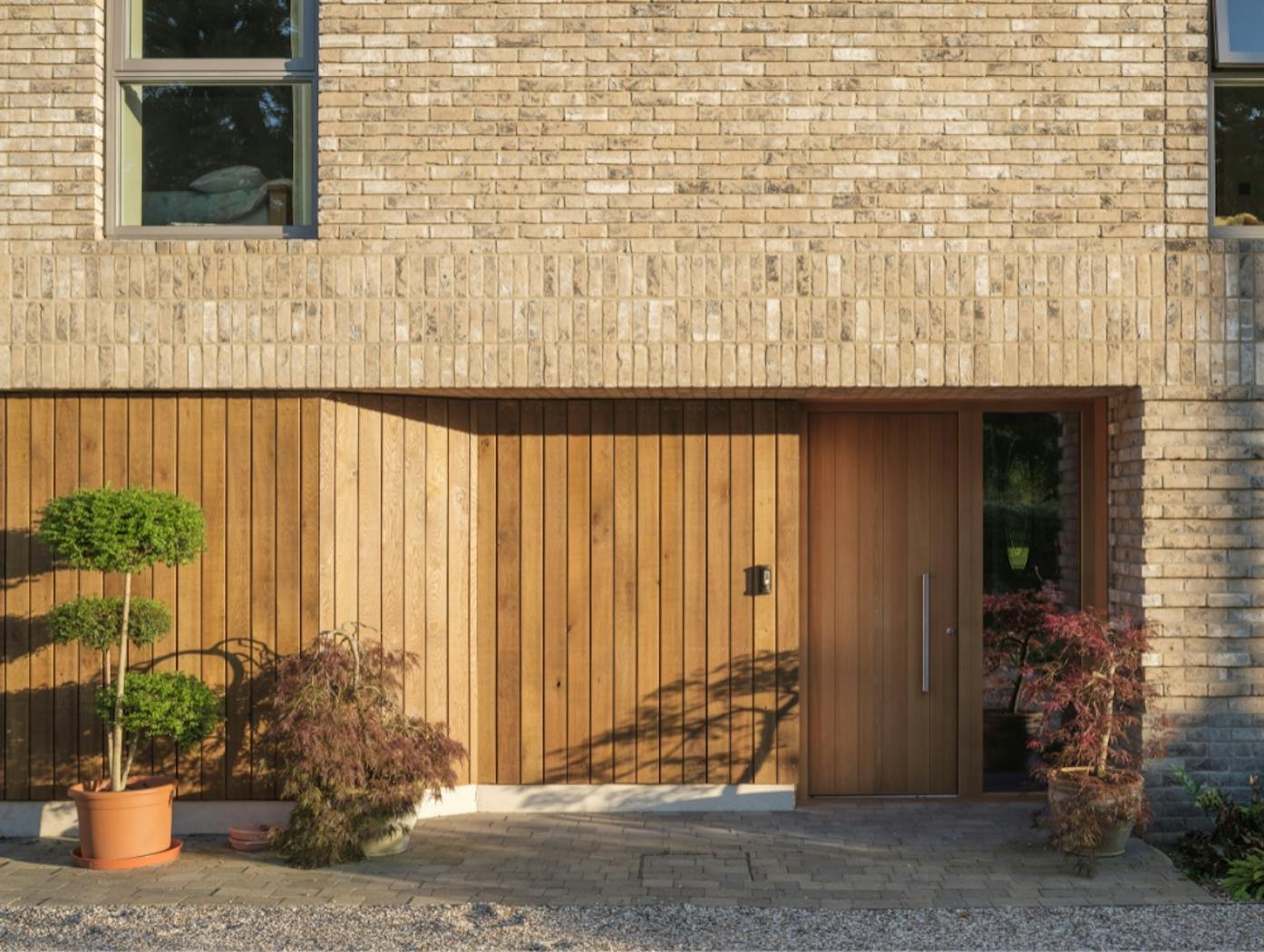Long House with a Passive front door in oak with matching cladding