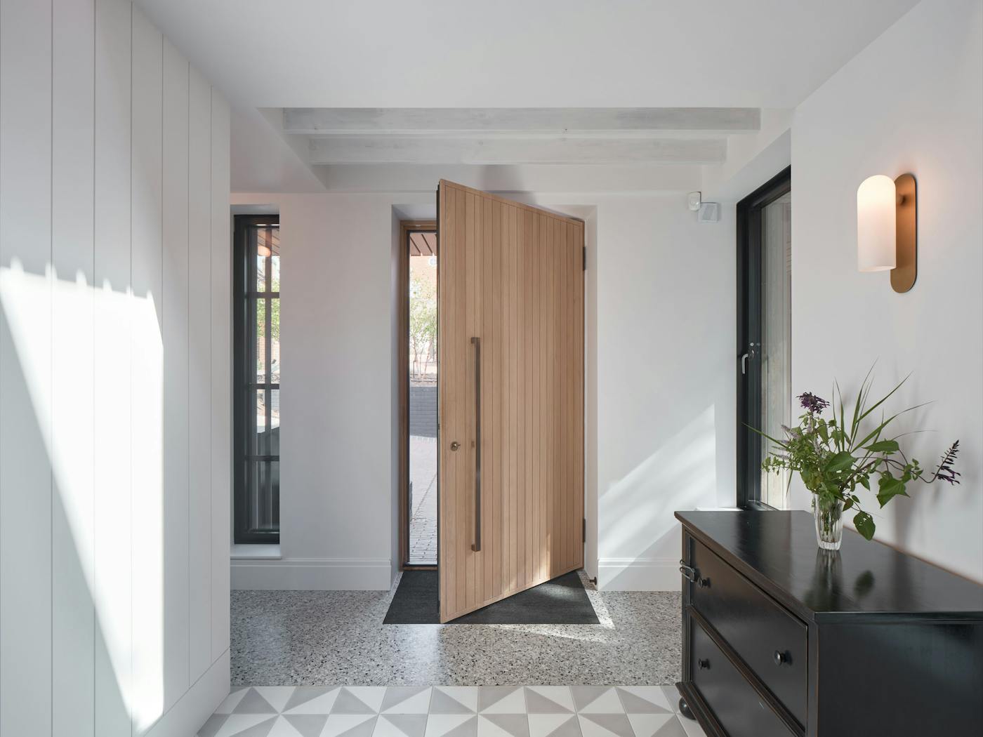 The wood of this passive dual door brings warmth to the hallway