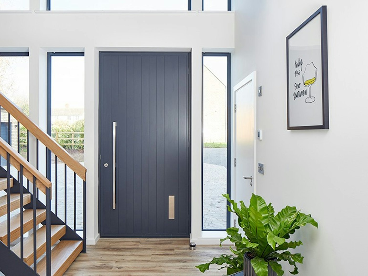 A picture-perfect anthracite grey front door with a contrasting light interior