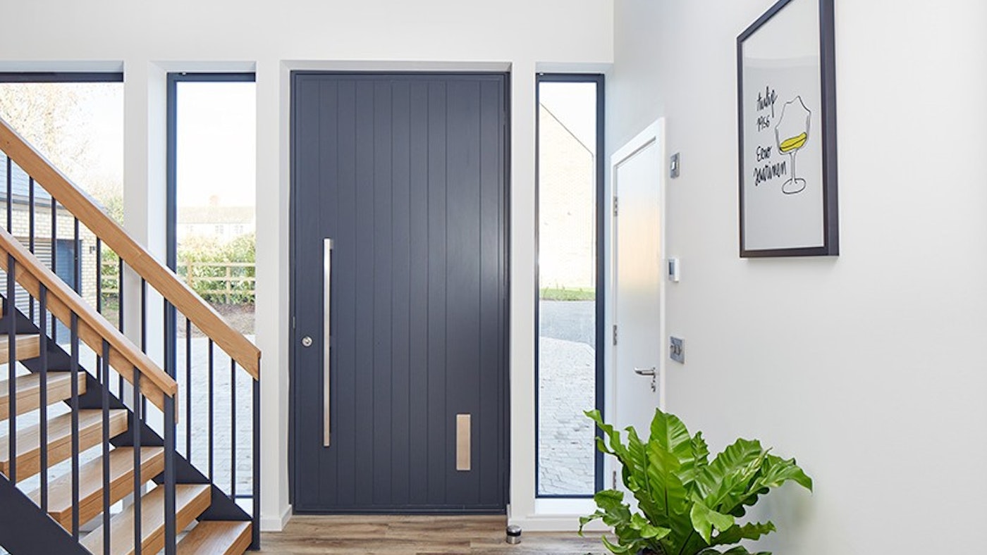 A picture-perfect anthracite grey front door with a contrasting light interior