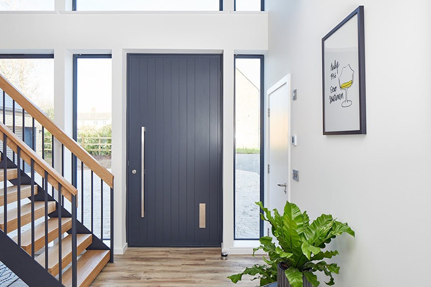 A picture-perfect anthracite grey front door with a contrasting light interior