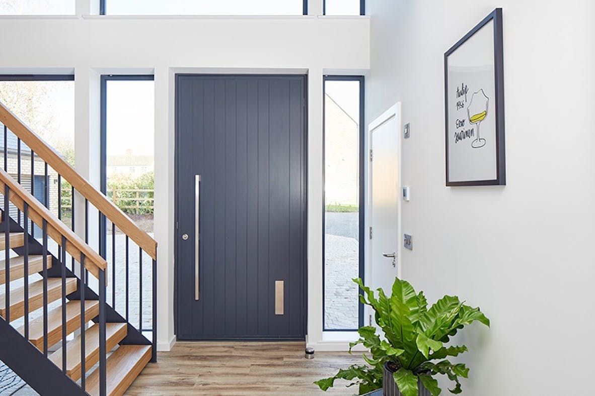 A picture-perfect anthracite grey front door with a contrasting light interior