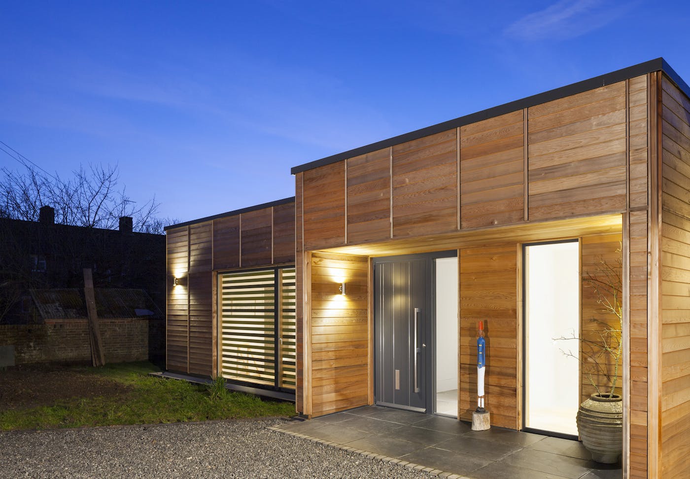 The simple building design works beautifully with the statement grey painted door