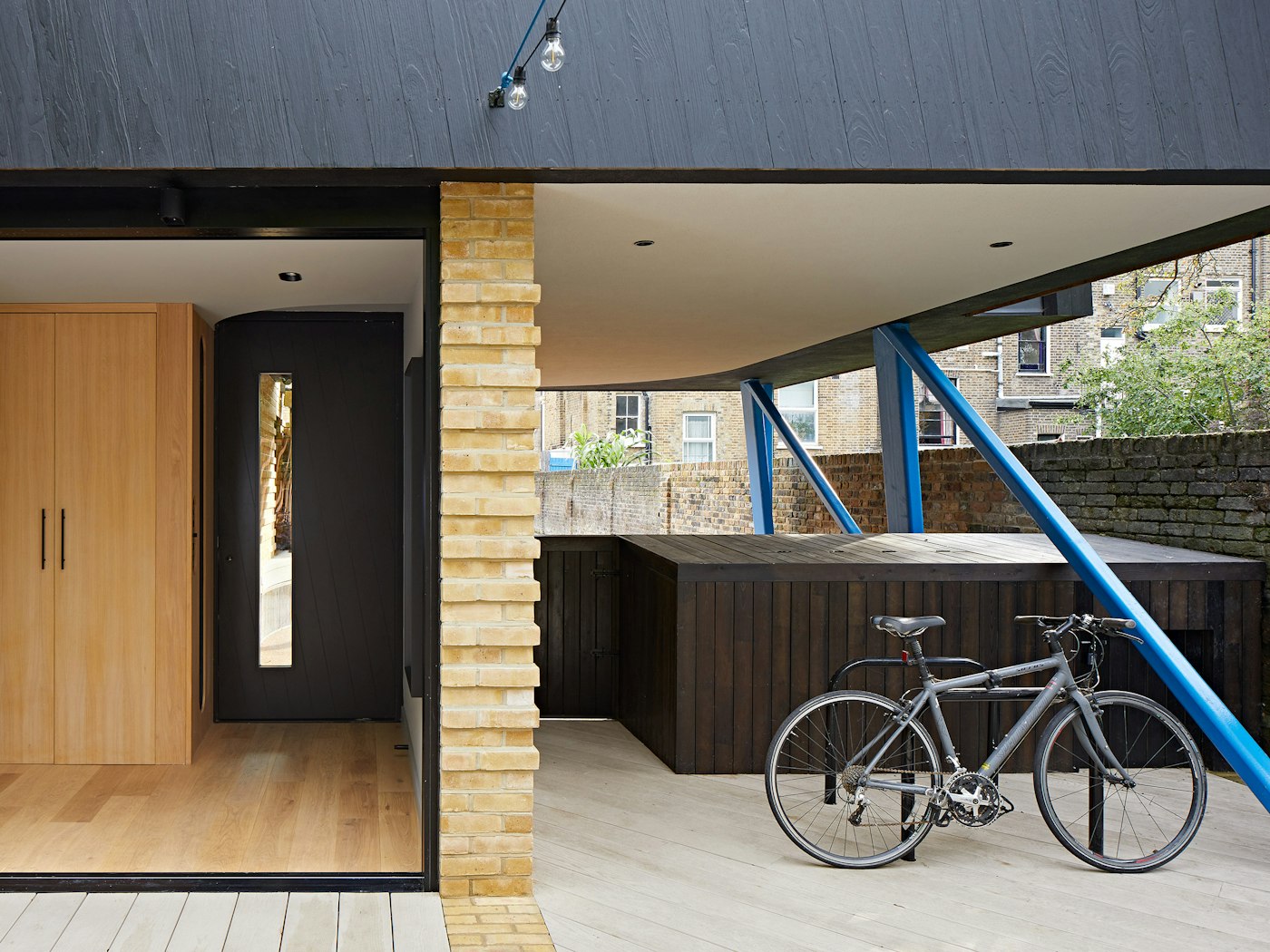 Housed within a variety of other building materials & colours, the black door & cladding offer the perfect neutral base