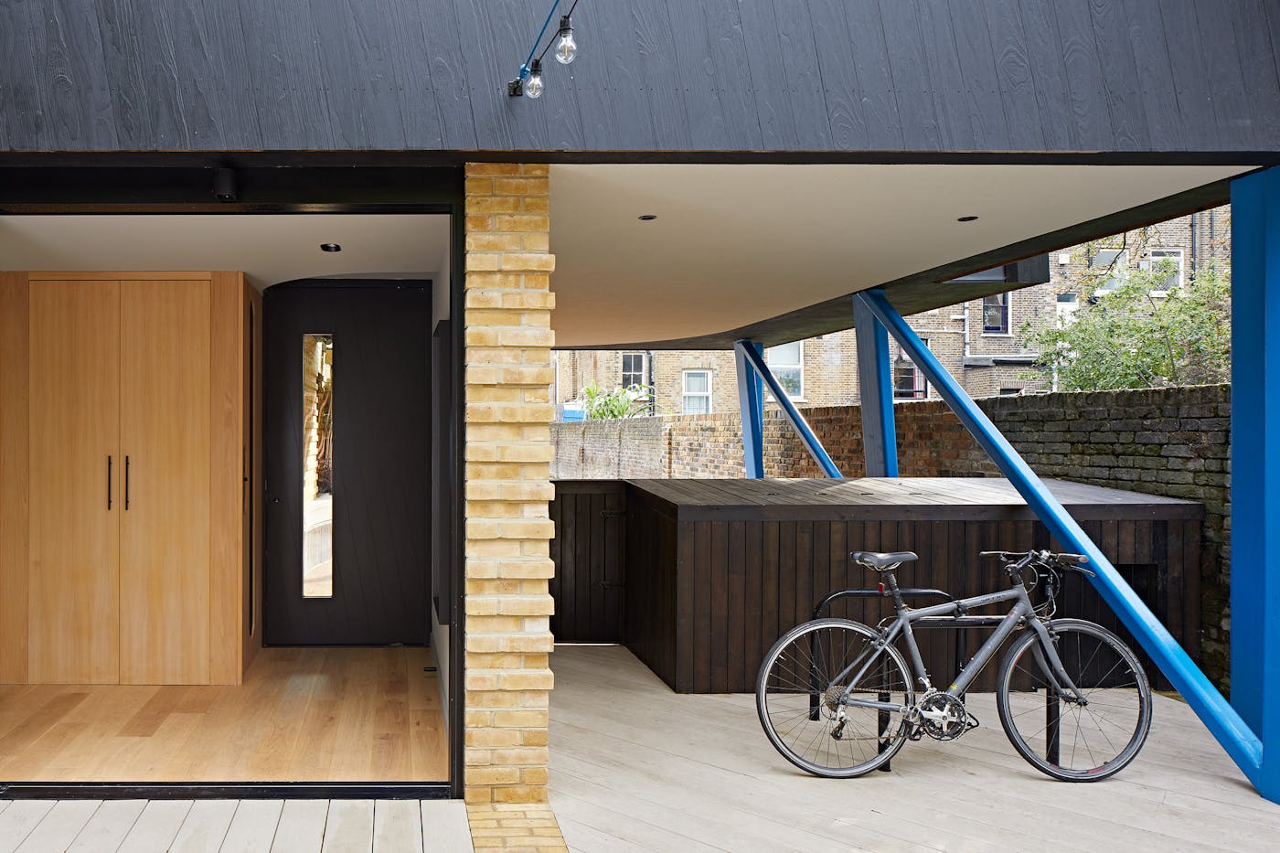 Housed within a variety of other building materials & colours, the black door & cladding offer the perfect neutral base