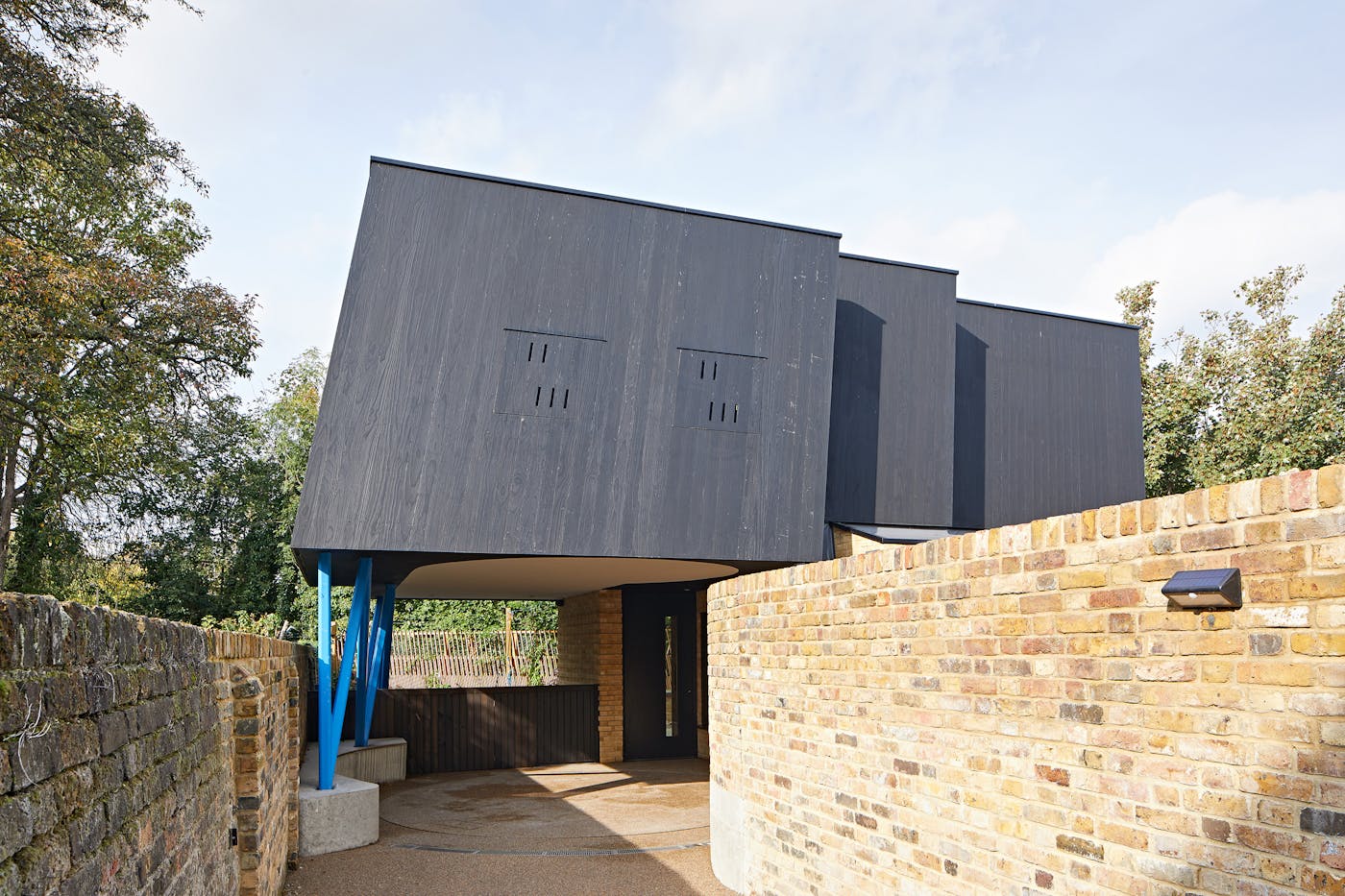 This unusual and fabulously contemporary design features our Terano black front door tucked away almost out of view