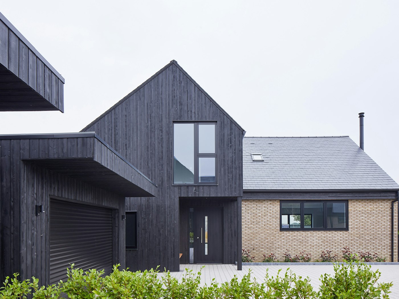 Urban Front's black painted Terano doorsets work well with the charred cladding in this development