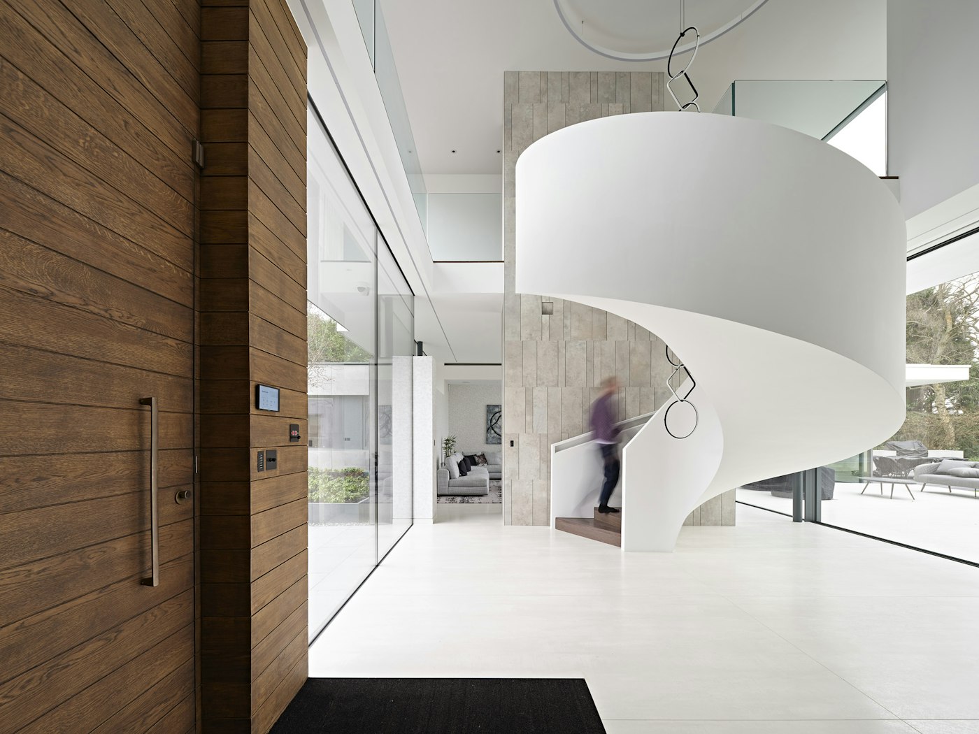 The entrance hall features a sweeping, spiral staircase