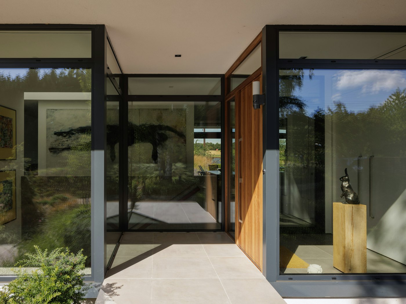 The door sits in the recessed porch of this heavily glazed eco house