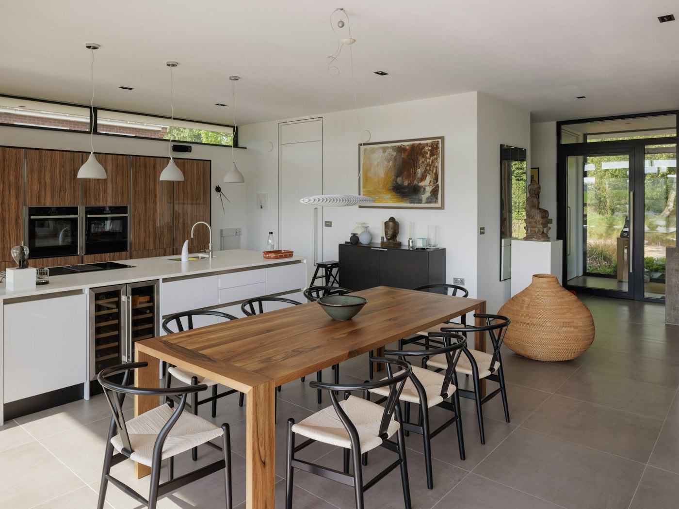 The modern kitchen/dining area is a bright and airy space