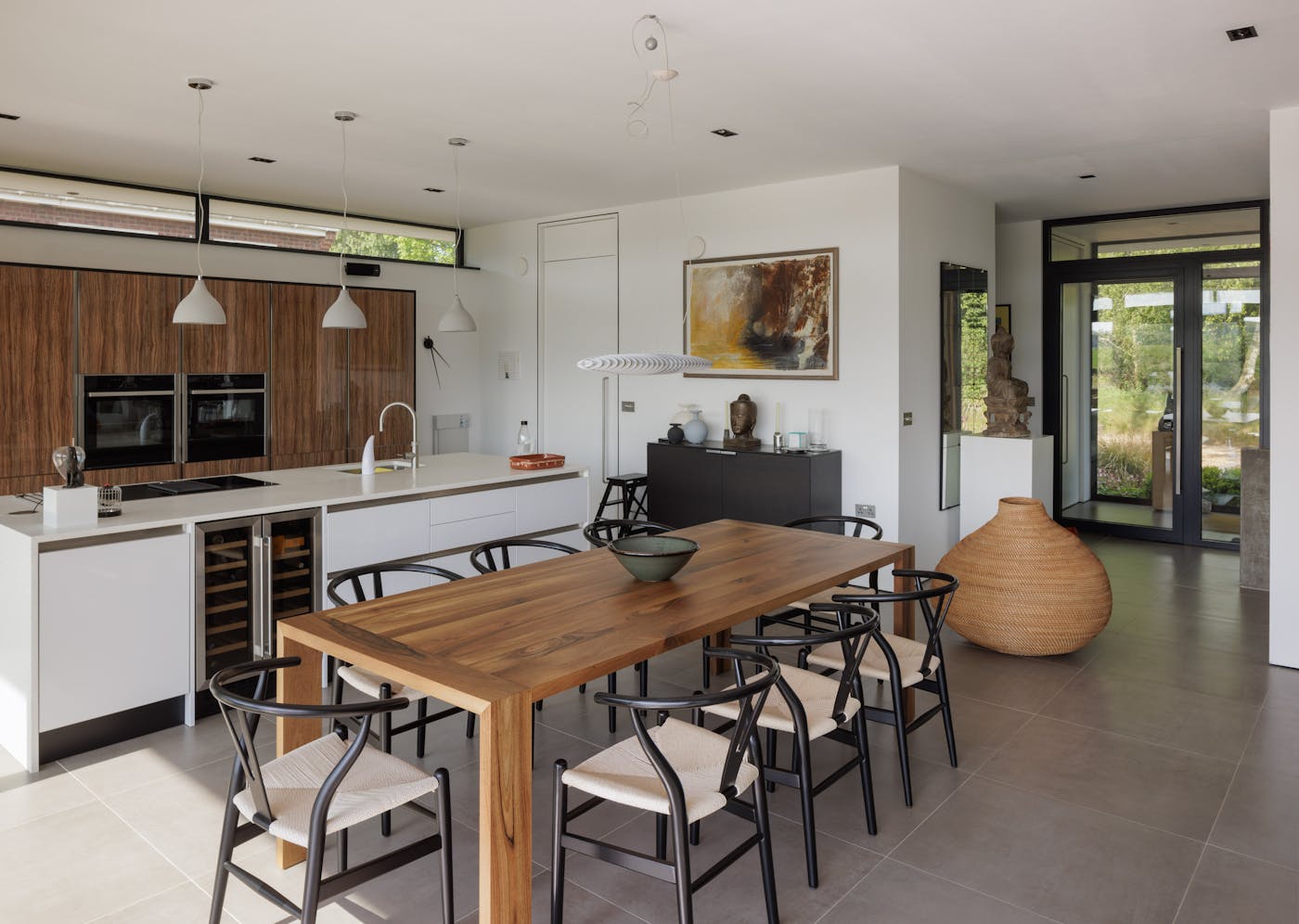 The modern kitchen/dining area is a bright and airy space