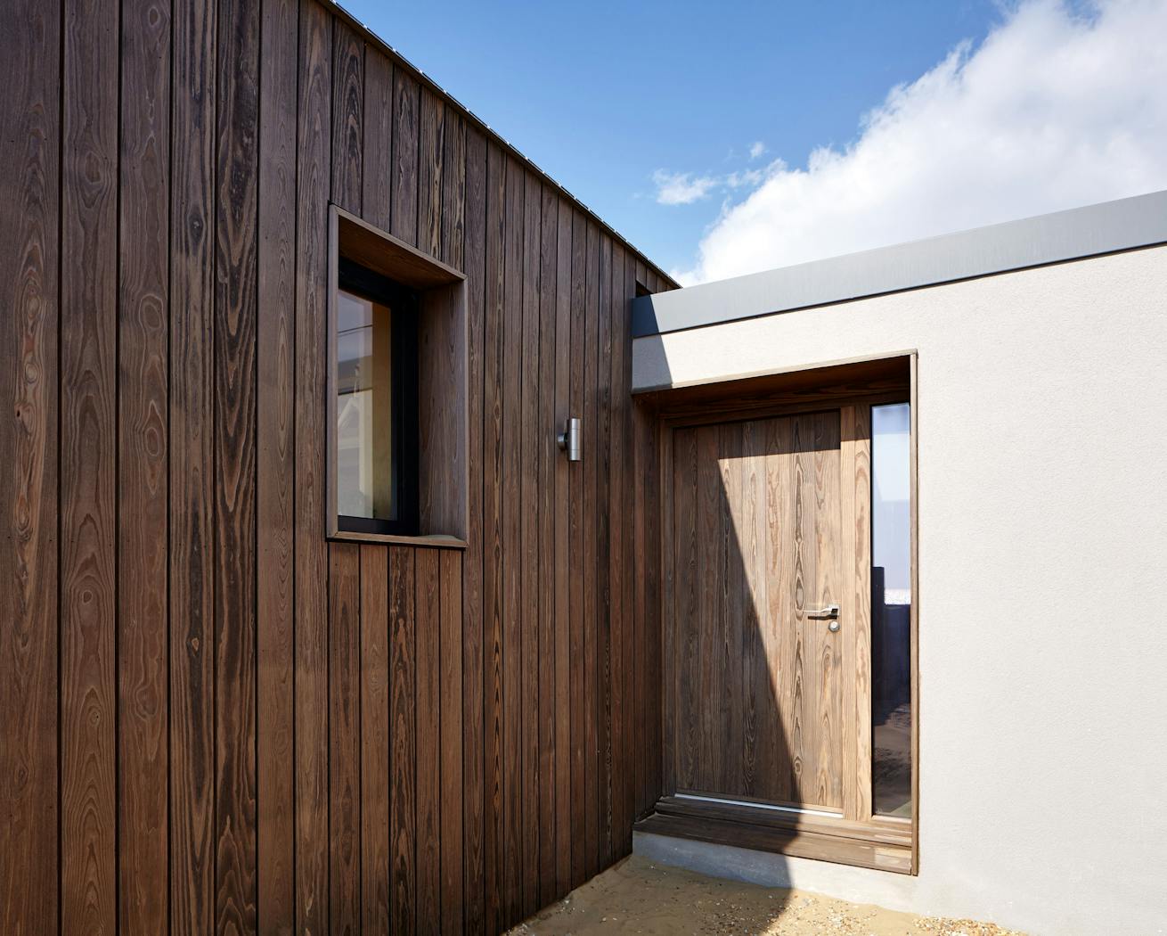 The contemporary Porto front door matches the exterior cladding