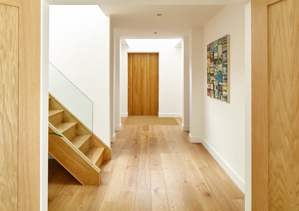 Inside, the european oak theme flows throughout this minimalist house