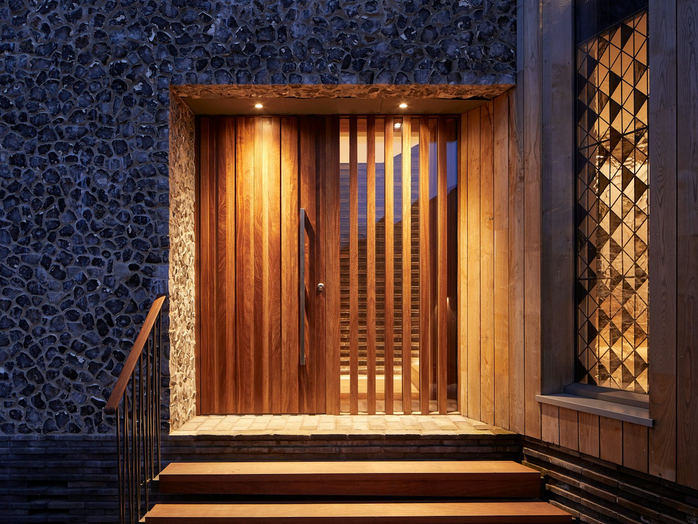 The Iroko has darkened beautifully and works very well with the other building materials