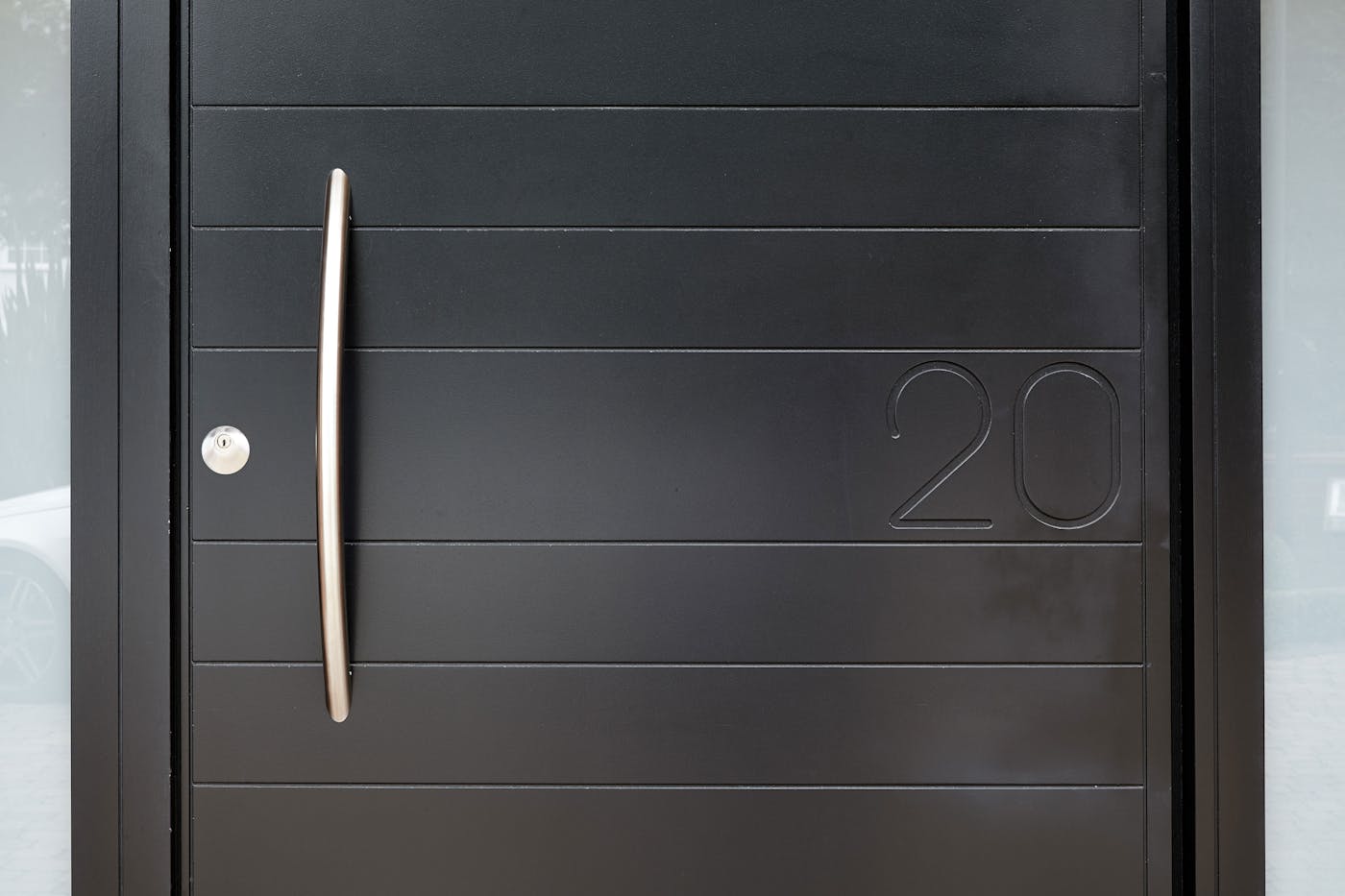 The house number is clearly visible but doesn't overpower the contemporary door