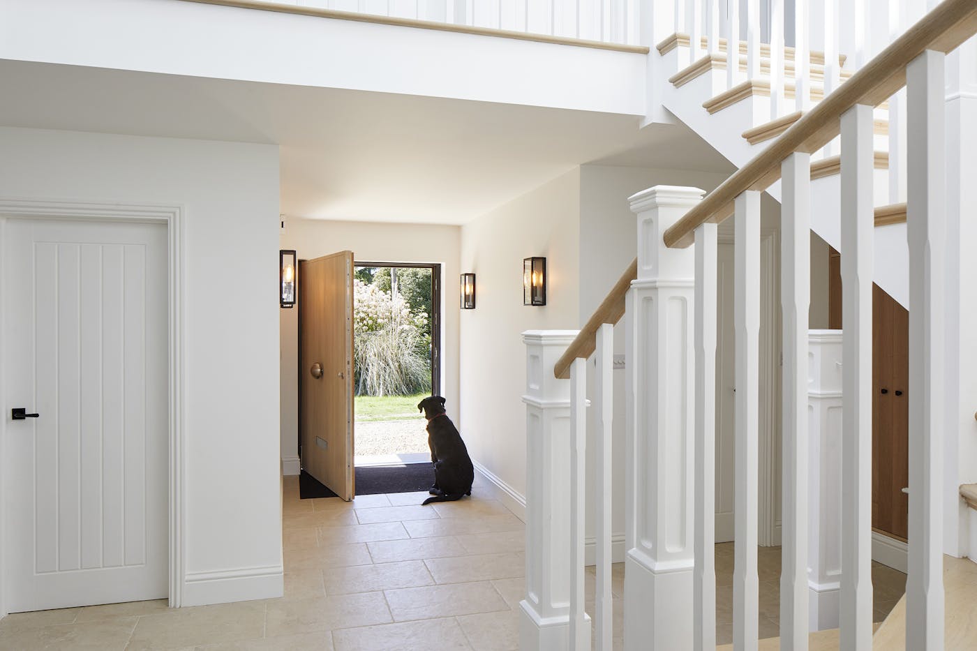 Venturing further inside, you can see how the oak front door ties in nicely to the interior detail on the stairs and bannisters